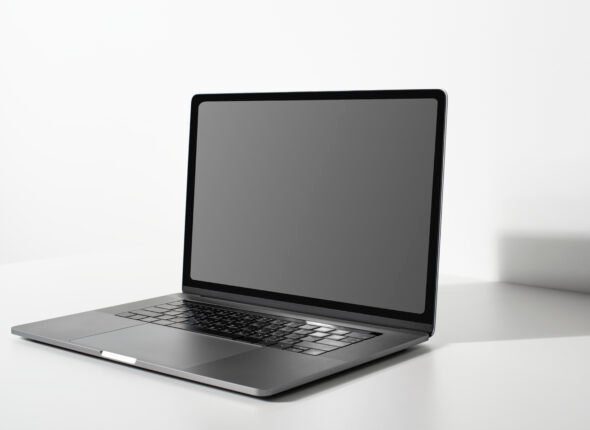 Laptop with blank black screen on a white table