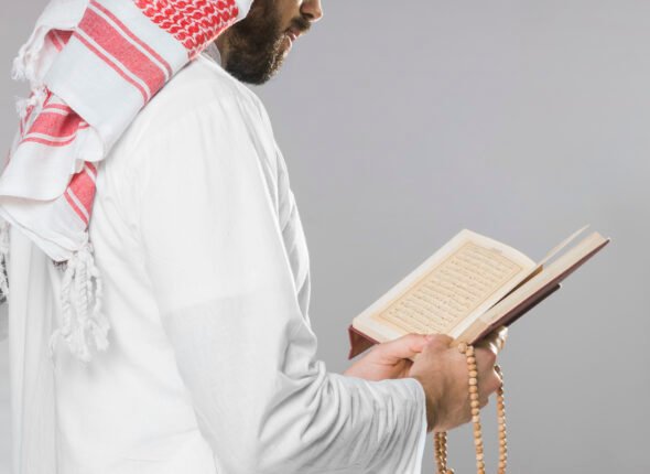 muslim-man-reading-from-quran-holding-praying-beads